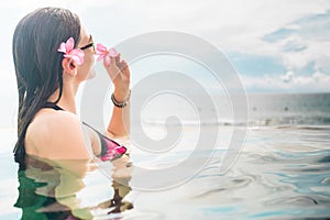 Female Tourist in infinity pool of hotel resort