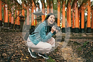 Female tourist kneel down taking picture