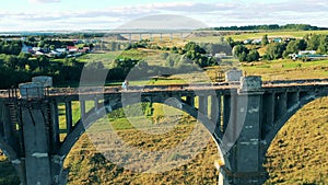 Female tourist is looking around while standing on a massive bridge