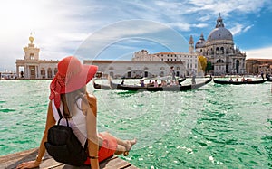 Female tourist looking the Basilica di Santa Maria della Salute and Canale Grande in Venice, Italy