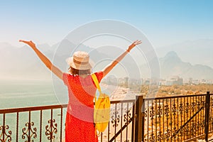 Female tourist looking from the height of the observation viewpoint overlooking Konyaalti beach in Antalya. Tourism and