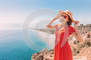 Female tourist looking from the height of the observation viewpoint overlooking Konyaalti beach in Antalya. Tourism and