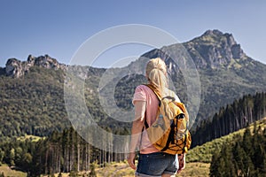 Female tourist looking at rocky mountain know as Velky Rozsutec in Mala Fatra, Slovakia