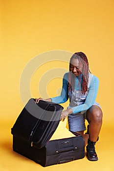 Female tourist packing bags for vacation