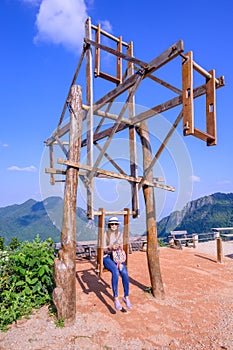 A female tourist playing hill tribe swing at Pha Hi village