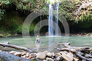 Woman Posing for photo at Maui, Hawaii Waterfall - Twin Falls in Motion, tourist stop on the Road to Hana