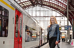 Female tourist on railway station platform, Europe