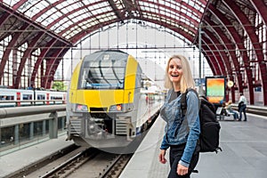 Female tourist on railway station platform, Europe