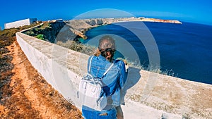 Female tourist at Sagres Fortress in Portugal