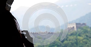 Female tourist taking a photograph of the Great Wall of China