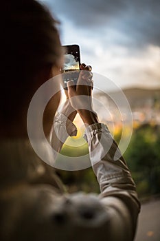 female tourist taking photos of a city while traveling