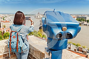 Female tourist taking photos of the old town of Budapest. Travel and view point concept