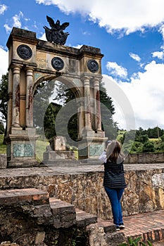 Female tourist taking pictures at the Arch of Triumph in Boyaca built in memory of the 3 races Mestizo, Creole and Spanish which