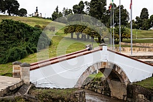 Female tourist taking pictures at the famous historic Bridge of Boyaca in Colombia. The Colombian independence Battle of Boyaca