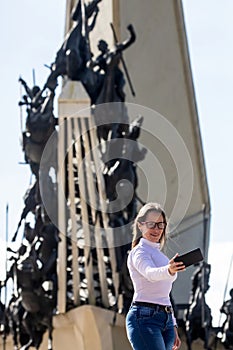 Female tourist taking selfies at the Vargas Swamp Lancers memorial located near Paipa city in Boyaca. Realized by Colombian