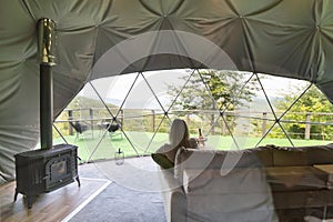 female tourist in transparent hotel dome.