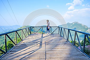A female tourist on viewpoint platform at Pha Hi village