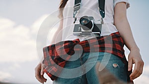 Female tourist with wintage camera. Lov angle no face shot