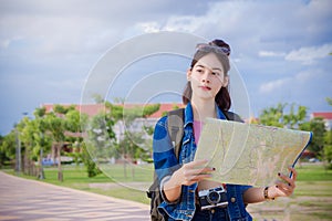 Female tourists Looking for destinations on the map in the town
