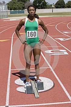 Female Track Athlete At The Starting Line