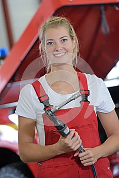 Female tractor mechanic posing