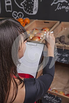 Female trainee counts fruits while the inventory