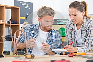 female trainee plumber working on central heating boiler