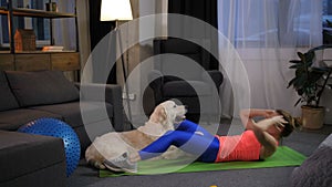 Female training abdominals under control of dog