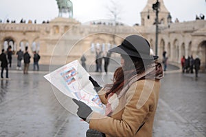 Female travel alone to see sightsee. Girl look at the map in old city