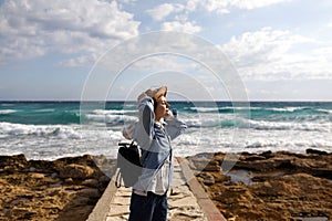 Female traveler admiring a marine view. tourism in Cyprus. tourist on sea background. girl travels on the beaches. young beautiful