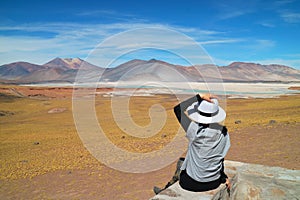 Female Traveler Being Impressed of Salar de Talar salt Lakes in Atacama Desert, Antofagasta Region of Northern Chile photo