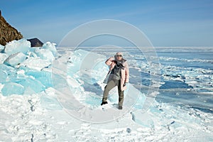 A female traveler at huge blocks of ice, hummocks on the ice
