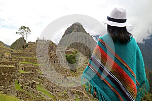 Female Traveler Looking at the Ancient Citadel of Machu Picchu, UNESCO World Heritage Site in Cusco Region of Peru