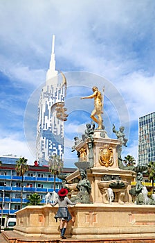 Female Traveler Looking Up to the Neptune Fountain on Theater Square in Batumi, Georgia