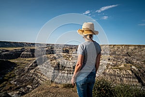 Female Traveler Looking at View at Horseshoe Canyon Near Drumheller in Alberta, Canada