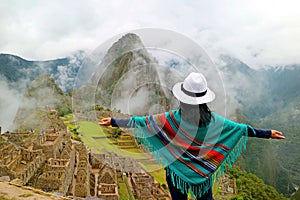 Female Traveler Opening Arms to the Amazing Ancient Inca Citadel of Machu Picchu, UNESCO World Heritage Site in Cusco Region