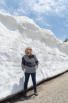 Female traveler and snow wall at japan alps tateyama kurobe alpine