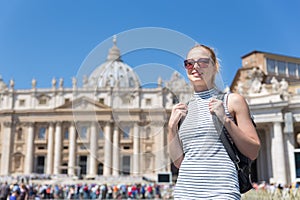 Woman on St. Peter`s Square in Vatican in front of St. Peter`s Basilica.