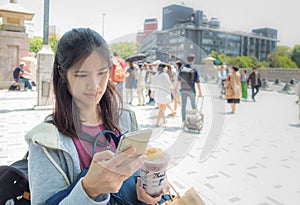 Female Traveler is using phone in Harajuku