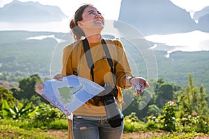 Female travelers are holding a map with money fifteen baht. The concept of tourism has little money can travel. The girl who