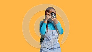 Female traveller using camera for photos photo