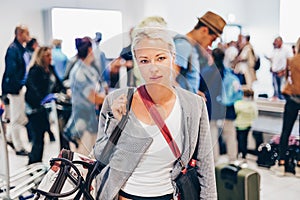 Female traveller waiting in airport terminal.