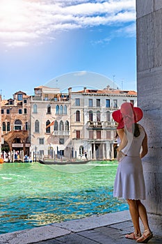 Woman enjoys the view to the architecture of the Canal Grande in Venice, Italy