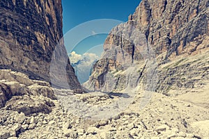 Female trekker walking along mountain valley.