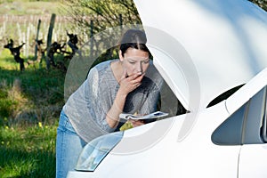 female trying to fix broken van