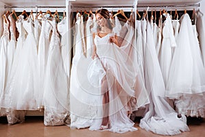 Female trying on wedding dress photo