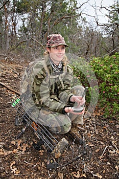 Female turkey hunter using a slate call