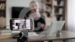 Female tutor working at home during distance learning and showing thumb up.