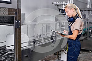 female in uniform checking and counting the quantity and quality of canisters