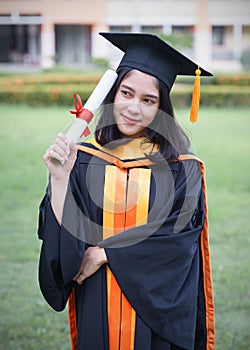 Female university graduates celebrate graduation with happiness after receive degree certificate in commencement ceremony. Asian